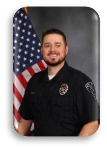 Headshot of officer with flag